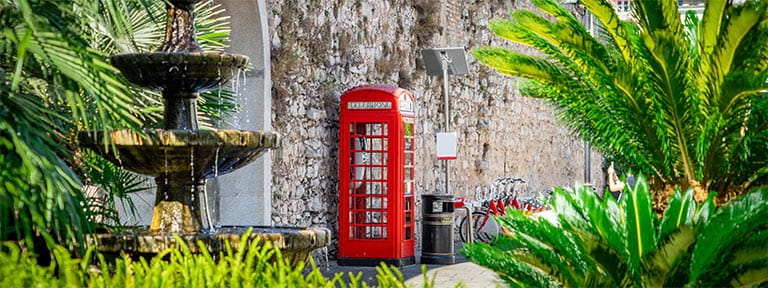 A British red telephone box on a street in Gibraltar